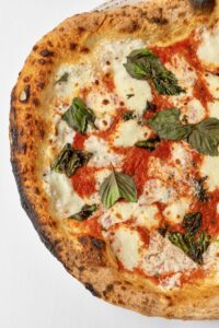 Authentic Margherita pizza with fresh basil cooked in a Josper oven at Mercato della Pescheria, the best wood fired pizza Las Vegas option