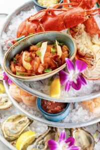 Seafood tower featuring lobster, salmon tartare, and fresh oysters at Mercato della Pescheria